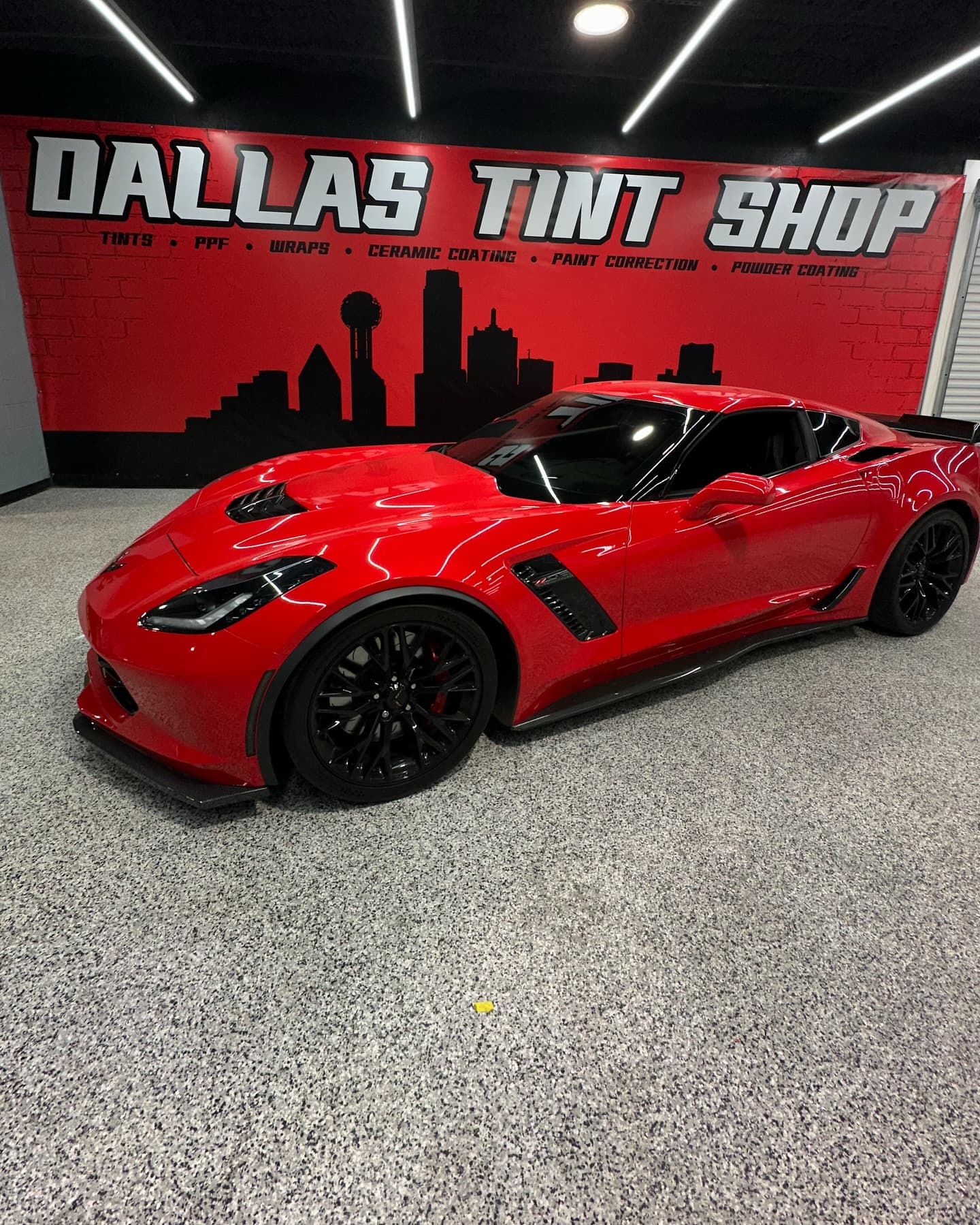Red Corvette Z06 in front of the Dallas Tint Shop mural