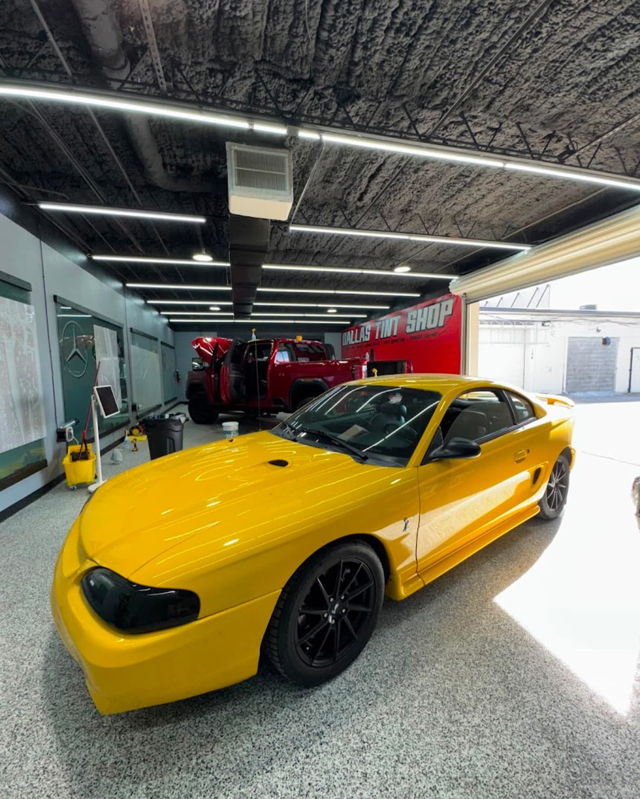 Yellow Porsche 911 in the Dallas Tint Shop bay