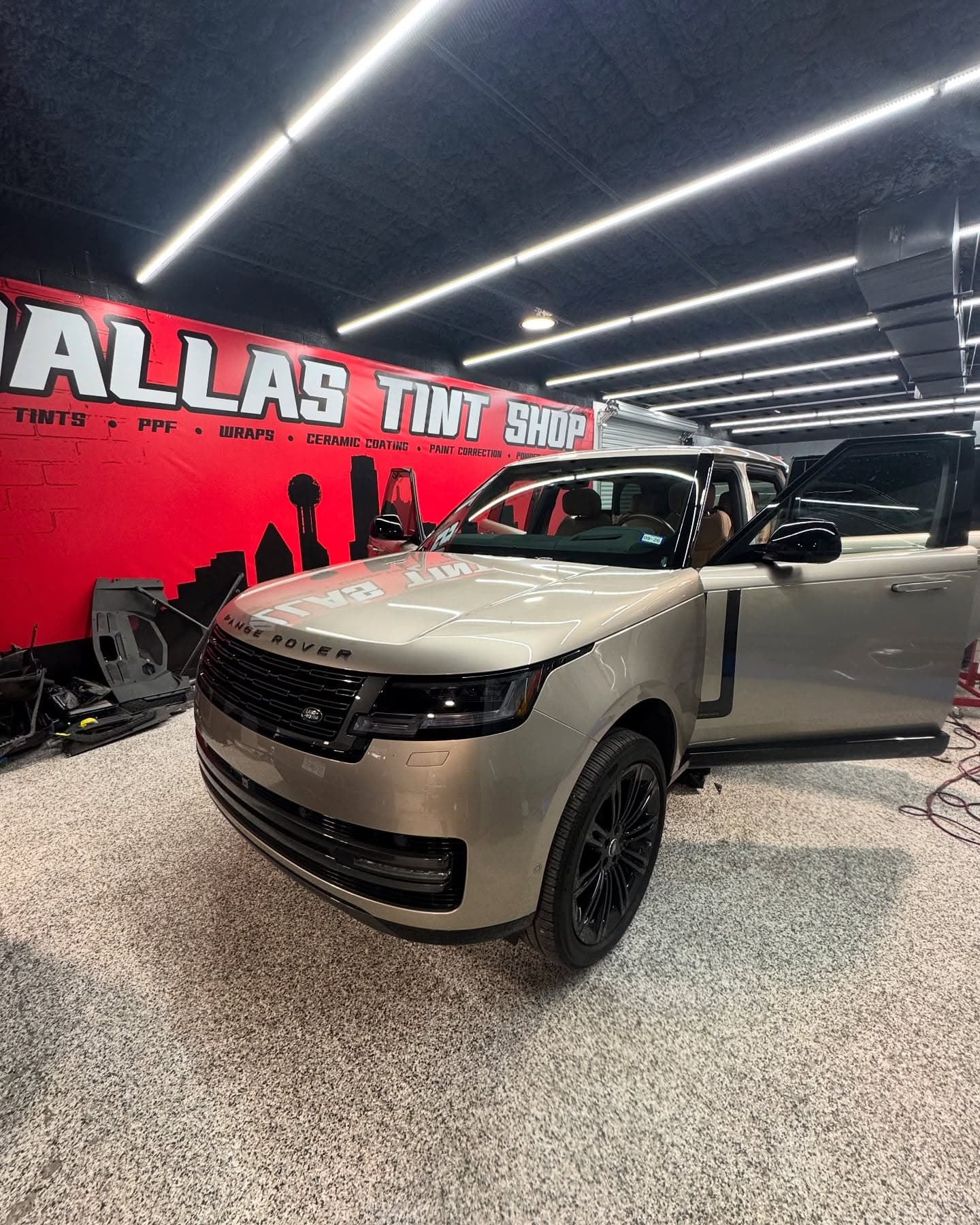 Champagne Range Rover with tinted glass under the shop lights