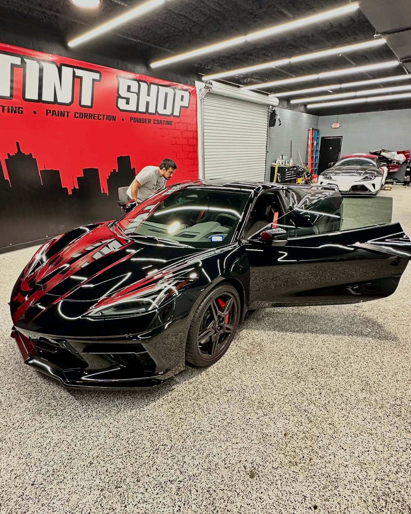 Black Corvette C8 with fresh window tint in the Dallas Tint Shop bay